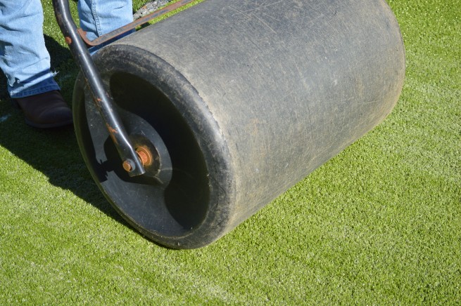 Greenwich artificial grass installation - top layer rolled